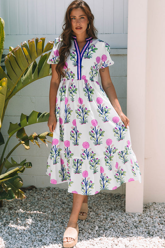 Robe longue blanche à fleurs, manches courtes bouffantes, col en V et taille haute