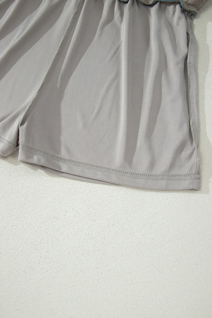 Ensemble 2 pièces jupe-short mini à cordon, veste zippée sport vert fumée à bord contrastant