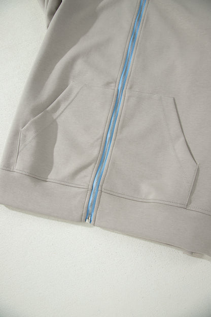 Ensemble 2 pièces jupe-short mini à cordon, veste zippée sport vert fumée à bord contrastant
